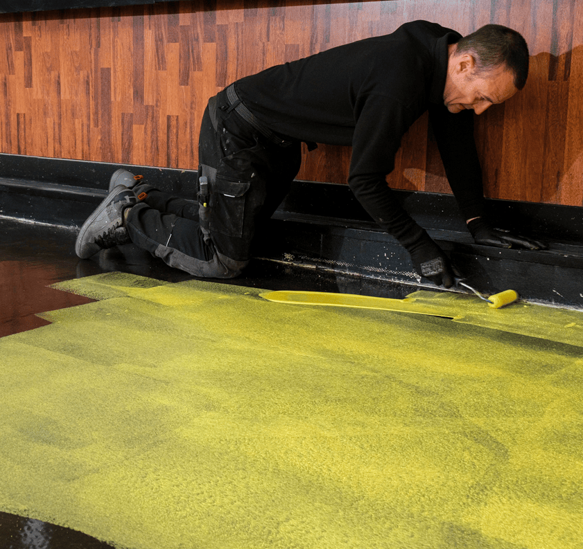 F. Ball's primer P141 being applied to a subfloor.