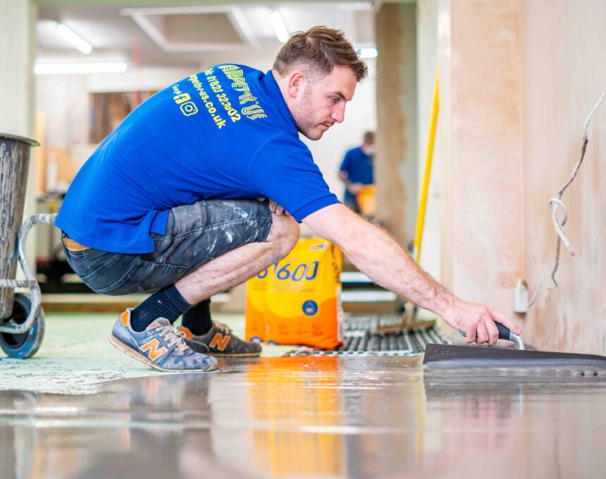 Stopgap 1600 smoothing compound being applied in flooring retailer, Carpets R Us, showroom based in Taunton.