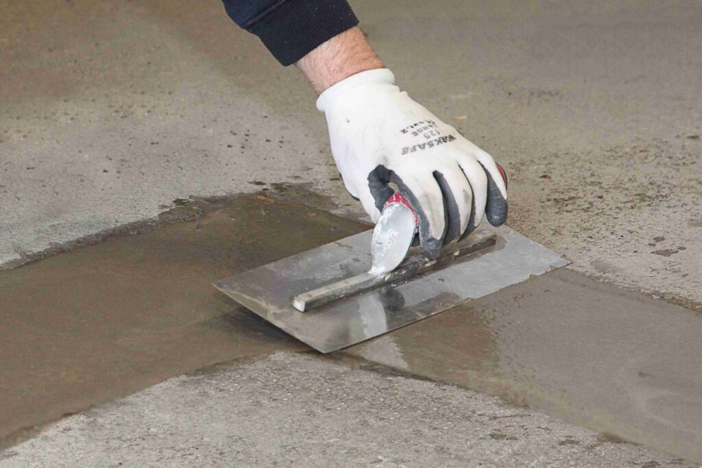 F. Ball's Stopgap 800 being trowel applied to create a wearing surface in a self-storage industrial unit.