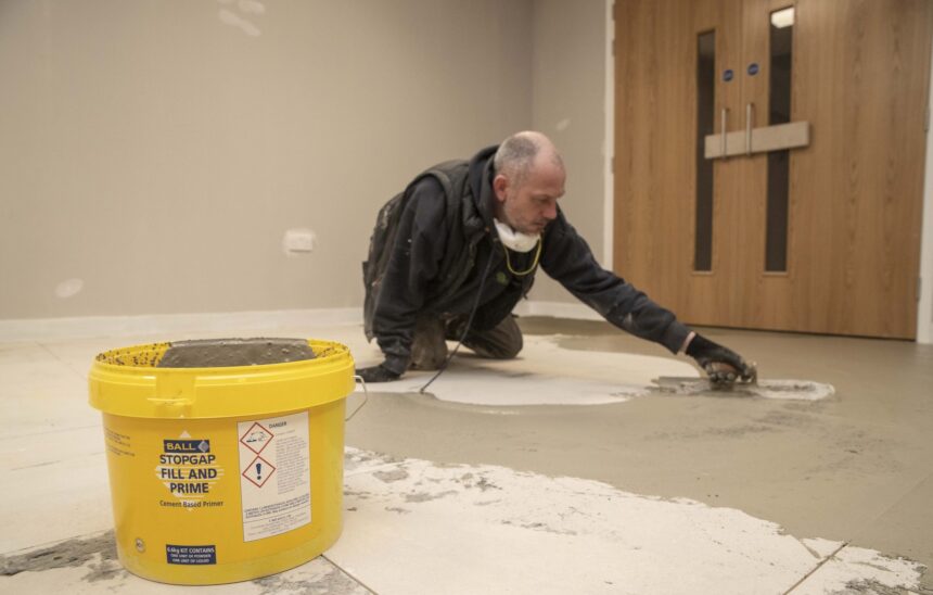 F. Ball's Stopgap Fill and Prime being applied over raised access flooring.